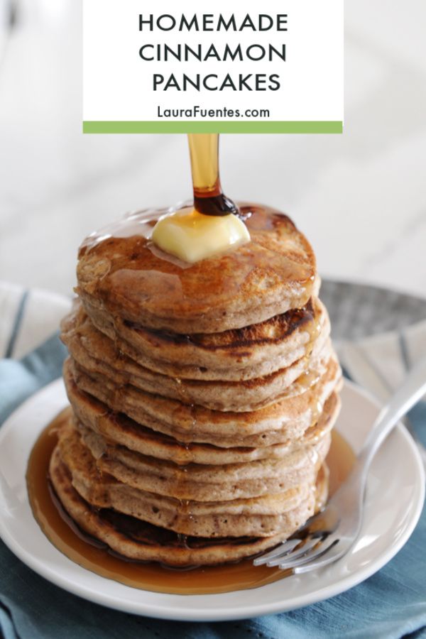 a stack of pancakes sitting on top of a white plate with syrup being drizzled over them