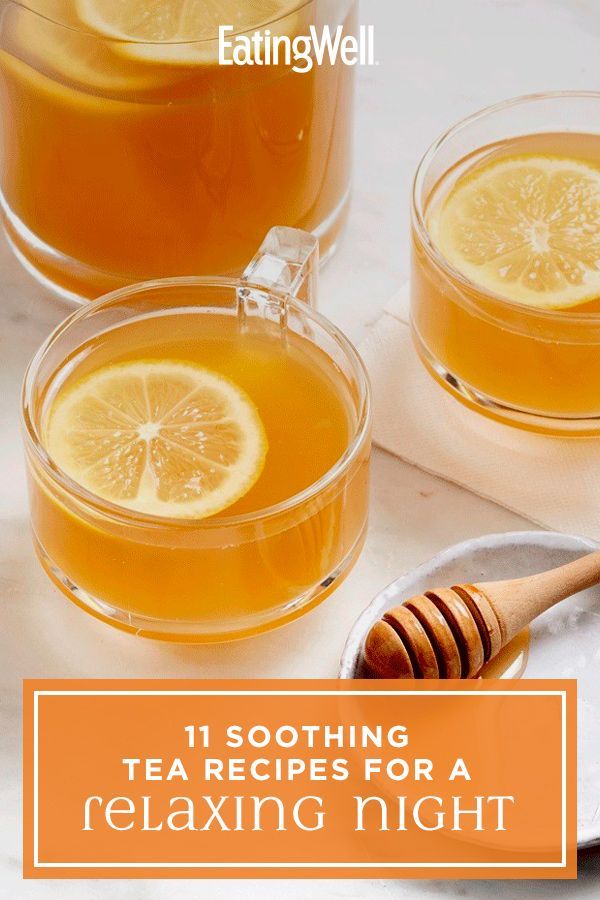 two glasses of tea with lemons and honey on the side, next to each other