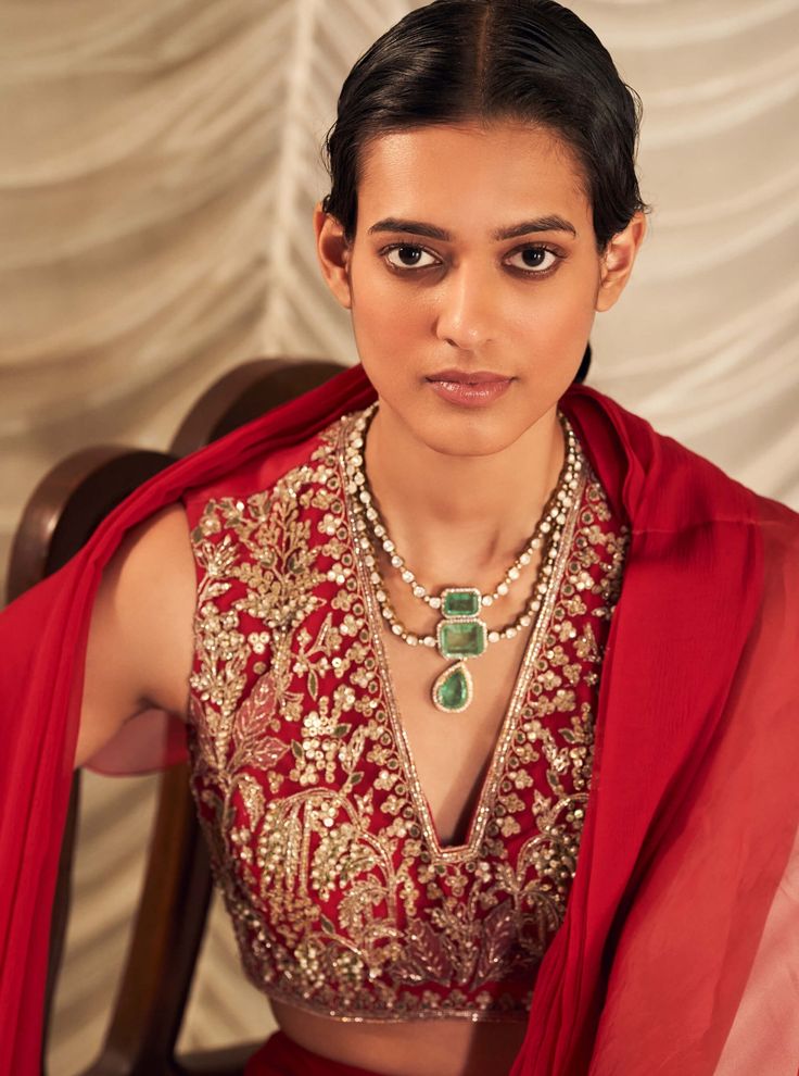 Elevate your style with the red net embroidered blouse, complemented by a chiffon drape saree and organza ruffle. The vibrant red blouse features exquisite embroidery that adds a touch of opulence, while the chiffon saree drapes elegantly for a fluid, graceful look. The organza ruffle introduces a modern, whimsical detail, creating a sophisticated ensemble perfect for any special occasion. Wedding Blouses, Saree Chiffon, Saree Drapes, Ridhi Mehra, Royalty Aesthetic, Ruffle Saree, Sari Blouse Designs, Embroidered Crop Tops, Drape Saree