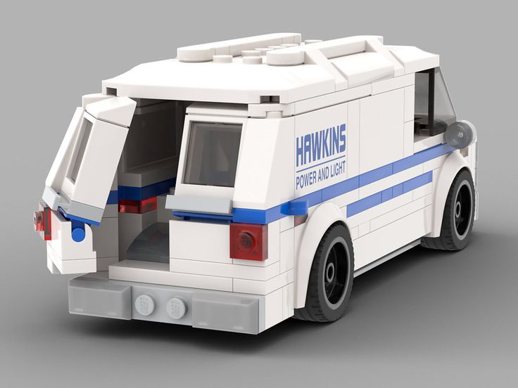 the back end of a lego police car with its doors open and lights on,