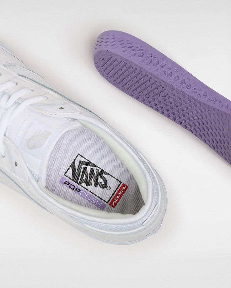 a pair of white and purple vans shoes next to each other on a white surface