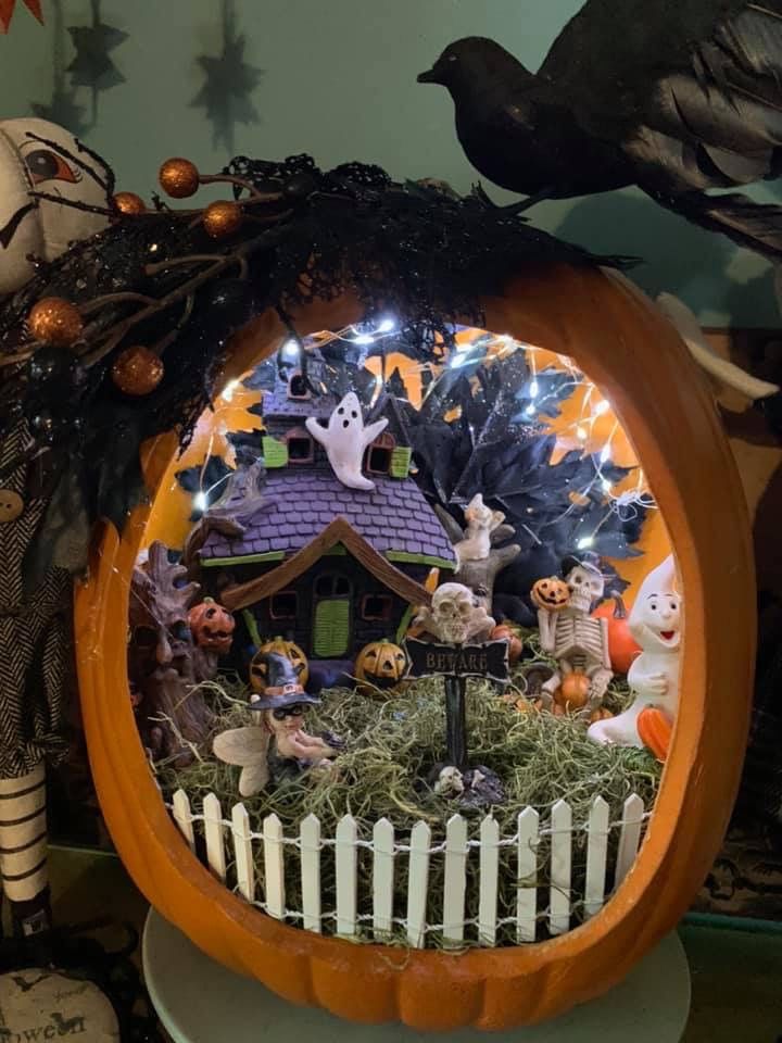 a pumpkin decorated with halloween decorations and lights