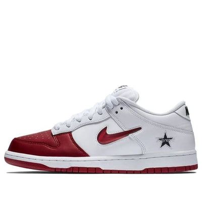 Nike and Supreme have partnered up once again, this time to release a special edition Nike SB Dunk Low skateboard shoe. This limited edition shoe is all white with a red synthetic toe box, and features jeweled Swooshes on the sides. The outsole has been updated with a semi-transparent rubber tread, and the shoe is finished off with embroidered co-branding throughout. (SNKR/Skate/Unisex/Low Top) Custom White Sneakers With Rubber Sole For Skateboarding, Sporty Red Skate Shoes With Vulcanized Sole, Red Vulcanized Sole Skate Shoes For Streetwear, White Custom Sneakers With Rubber Sole For Skateboarding, University Red Skate Shoes For Streetwear, Red Sneakers With Vulcanized Sole For Streetwear, Red Sporty Skate Shoes With Vulcanized Sole, White Skate Shoes With Vulcanized Sole, White Skate Shoes With Boost Midsole