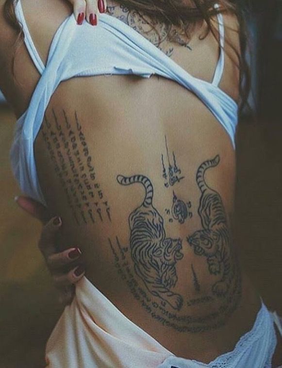 a woman with tattoos on her back