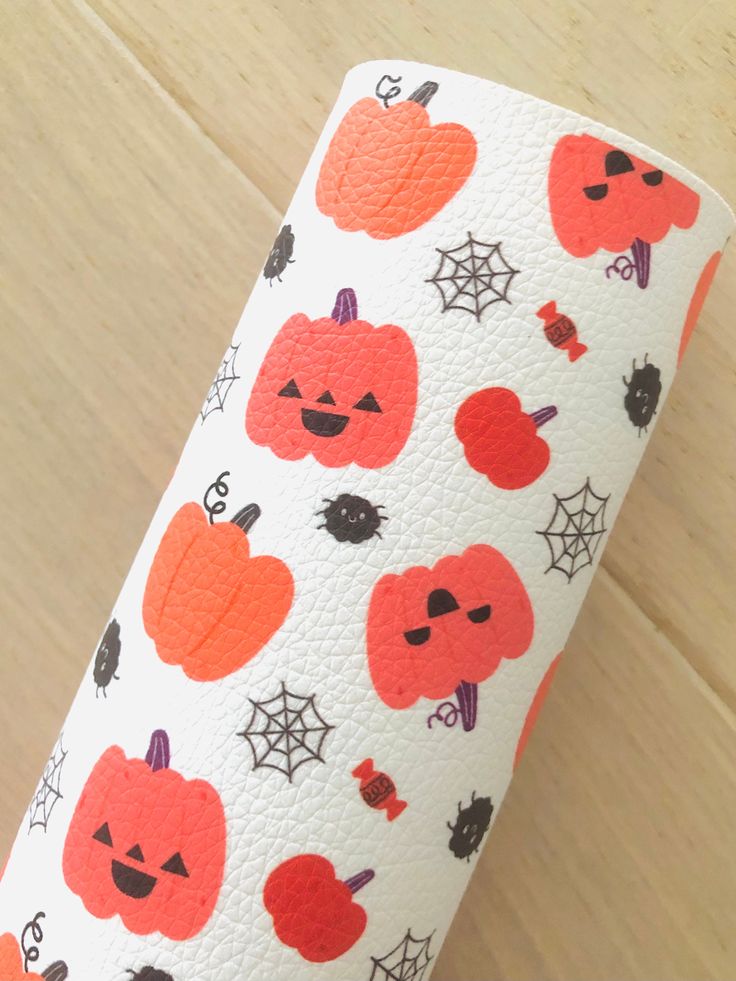 a roll of toilet paper with pumpkins on it