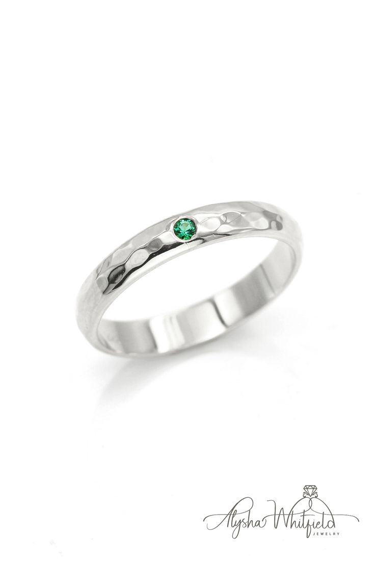 A simple emerald wedding band design with a luxurious hammered finish.  Natural gemstone in Yellow Gold. Rustic, vintage, modern and earthy Timeless Green Round Band Jewelry, Classic Green Jewelry For Promise Occasions, Elegant Stackable Emerald Ring For Anniversary, Sterling Silver Promise Ring With Thick Band, Classic Emerald Promise Ring With Birthstone, Formal Green Stackable Rings, Fine Jewelry Stackable Emerald Ring With Round Band, Classic Stackable Round Cut Emerald Ring, Classic Stackable Emerald Ring With Round Cut