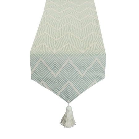 a white and blue table runner with tassels