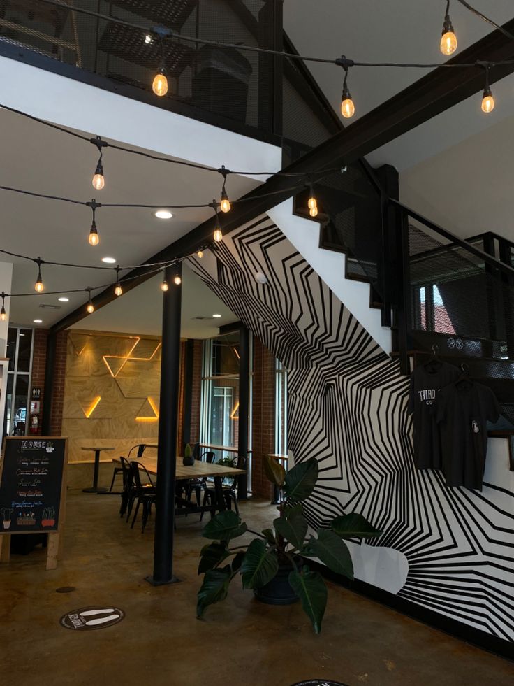 the interior of a restaurant with lights hanging from the ceiling and zebra print on the wall