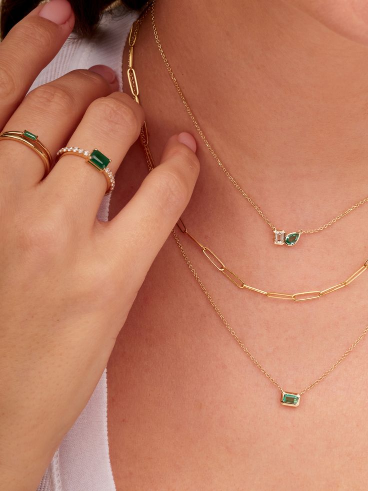 This is your classic diamond band with a BIG pop of color! We are obsessed with this emerald baguette set in the center of the band. You can add this to any ring stack or wear on it's own! Please email hello@shoplemel for different stone color options. Emerald Stone Jewelry, Gold And Emerald Necklace, Emerald Accessories, Emerald Ring Simple, Emerald Pendant Necklace, Tiny Heart Necklace, Baguette Necklace, Jewellery Photography Inspiration, Emerald Necklace Pendant