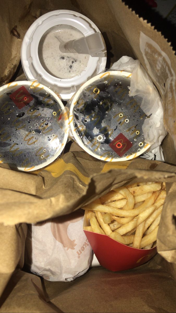 a bag full of french fries next to some other food in it's wrapper