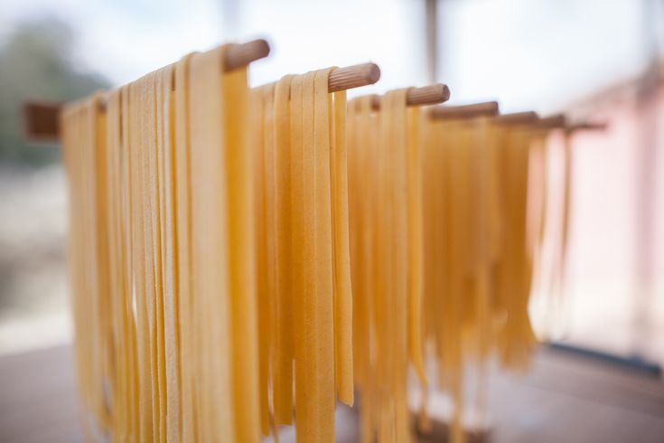 several pieces of pasta are lined up on a rack in front of a glass window