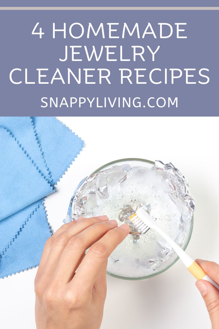 a person holding a toothbrush over a glass filled with water and ice cubes