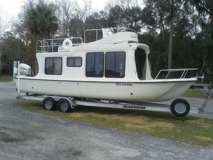 a white boat sitting on top of a trailer