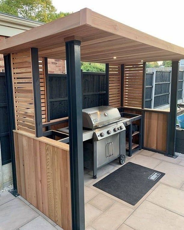 an outdoor kitchen with bbq and grill area