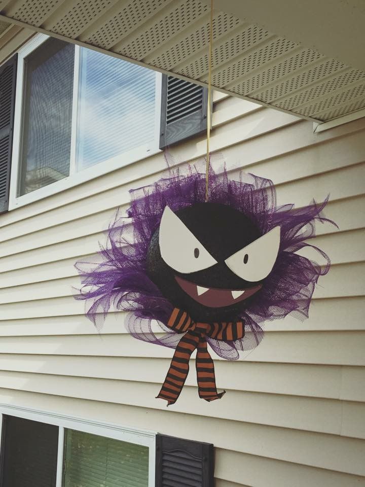 a halloween decoration hanging from the side of a house