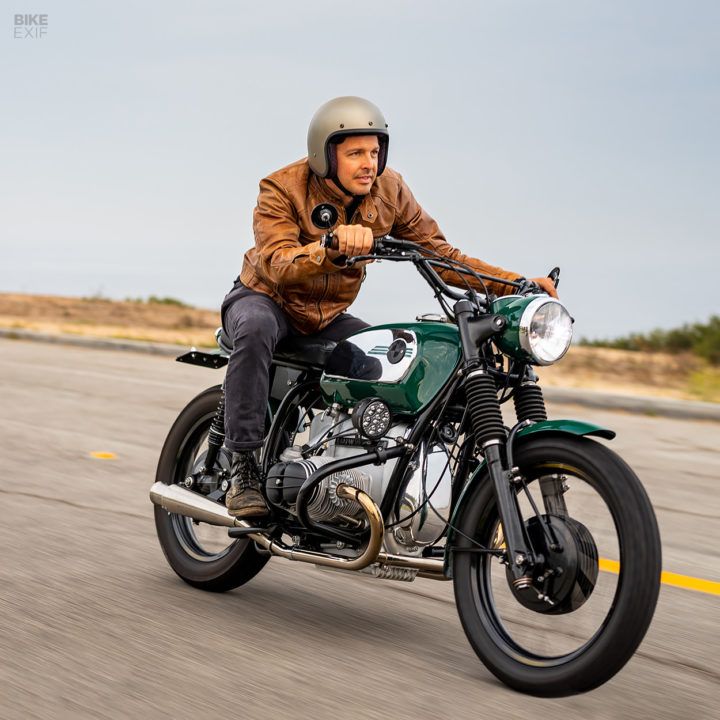 a man riding on the back of a green motorcycle