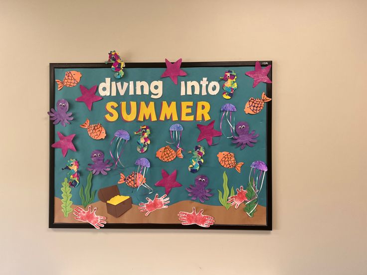 a bulletin board that says diving into summer with sea creatures and corals on it