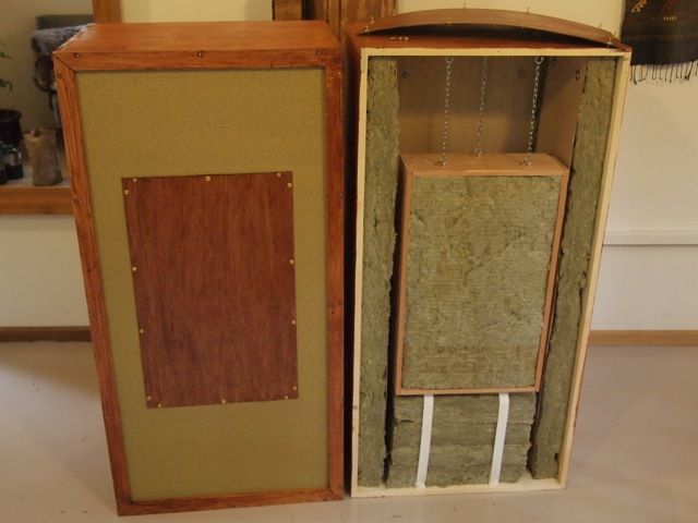 two wooden boxes are stacked on top of each other in the middle of a room