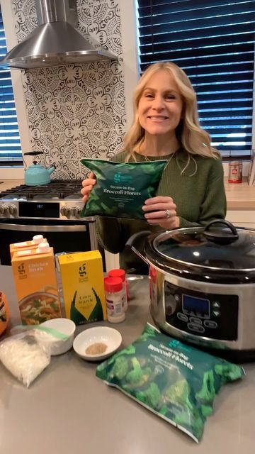 a woman sitting in front of an instant pot with ingredients on the counter next to her