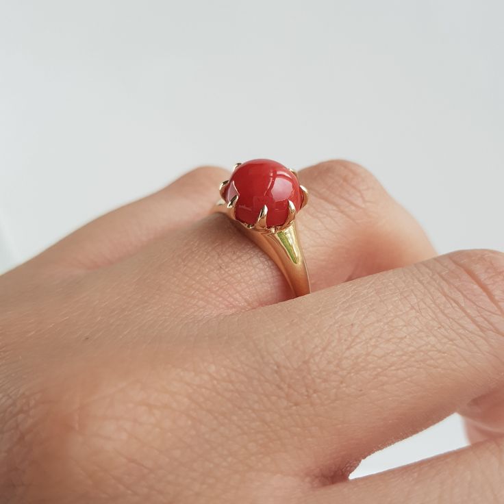 RING DETAILS: ✪Design: Gold ring ✪Gemstone: Natural coral ✪Gemstone color: Red ✪Gemstone size: 9mm Gemstone weight: 2.15mm ✪Gemstone shape: Round ✪Setting type: Prong Gold weight: 2 gram ✪Metal type: 14k solid yellow gold ✪Metal finish: Smooth shiny Choose your ring size from drop down menu and if you need any other preferred ring size please contact us. QUALITY OF MATERIALS: Metal: Most of our jewelry at JewelryMansion is made with precious metals like gold and silver. These metals are 100% non Coral Stone Ring Design For Women, Gemstone Signet Ring With Round Band As A Gift, Red Jewelry With Center Stone In Round Band, Red Jewelry With Center Stone Round Band, Red Solitaire Ring With Round Band, Red Jewelry With Accent Stones And Round Band, Red Jewelry With Round Stone In Prong Setting, Yellow Gold Dome Ring With Gemstone For Gift, Red Round Stone Promise Ring