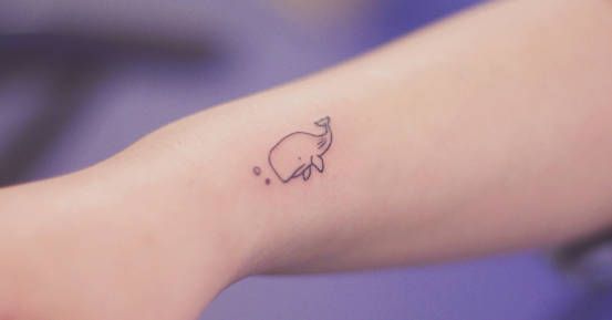 a small elephant tattoo on the arm