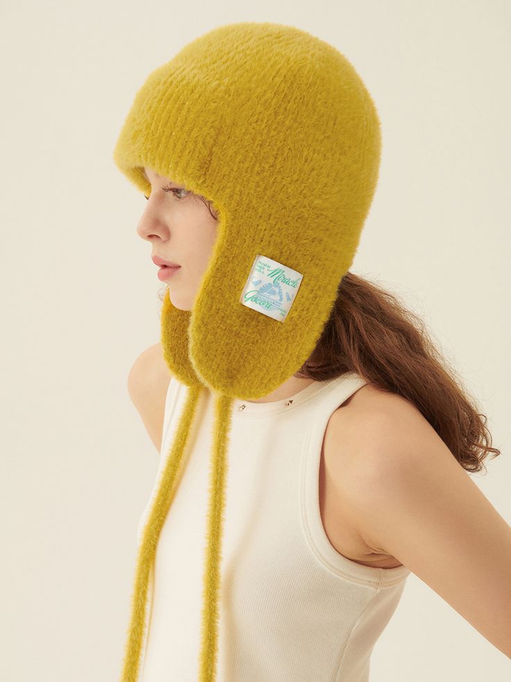 Editor's NoteGOCORI is a designer brand that unfolds collections through fashion aesthetics and beliefs that pursue the identity of a City Gardener, with a storytelling approach.- Trooper style hat- Made of warm angora and wool blended fabric- Artwork label patch at the ear flap- Self-tie straps attached- Cozy and adorable moodMeasurements(in.)One Size- Length: 13.78 in.- Wrist Width: 10.24 in.  Composition & Care- Material: 30% Angora, 20% Wool, 45% Acrylic, 5% Spandex- Dry clean only- Do not bleach- Do not twist- Do not tumble dryDesigner- by GOCORI Warm Ear Flaps Hat For Fall, Warm Fall Hat With Ear Flaps, Warm Fall Hats With Ear Flaps, Warm Winter Bonnet With Curved Brim, Adjustable Ear Flap Hat For Fall, Winter Brimmed Bonnet, Winter Brimmed Fitted Bonnet, Adjustable Fall Hat With Ear Flaps, Adjustable Ear Flaps Hat For Fall