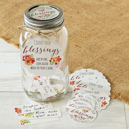 a mason jar with some tags on it sitting next to other items that include tags