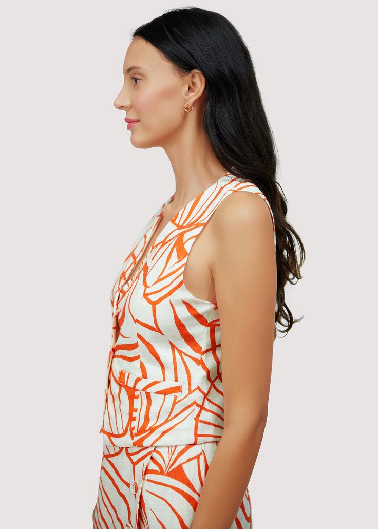 Introducing our Salt To The Sea Vest Top - a fun, feminine addition to your summer wardrobe. Made with a breathable cotton blend fabric, this abstract palm print top will keep you cool and stylish all season long. Perfect for hot days and chic nights. WTWH02858 Imported Lined Self: 70% Cotton 30% Linen Lining: 100% Rayon Model is 5 ft 9.5 inches; Bust: 32", Waist: 24", Hips: 34" and wearing a size Small Runs true to size Hand wash or wash with gentle cycle with cold water with like colors, Air d Spring Bold Print Orange Tops, Fitted Abstract Print Summer Tops, Tropical V-neck Top For Summer, Chic Summer Tops With Abstract Print, Spring Cotton Tops With Abstract Print, Chic Orange Printed Top, Casual Summer Tops With Abstract Print, Printed Sleeveless Beachwear Top, Trendy Cotton Tops With Bold Print