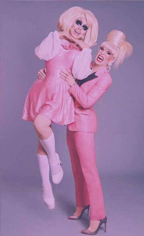 two women dressed in pink posing for a photo