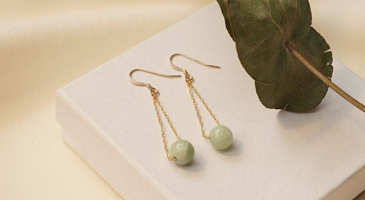 Natural Green Jade 14K Gold Filled Earrings nāu jewelry is made of high quality 14k Gold Filled materials only, which are skin friendly, durable, affordable, and can be worn every day without tarnishing. These delicate green jade earrings are carefully handmade with 14k gold filled findings and natural green jade beads. Jade Healing Properties Jade has many meanings, including strength, luck, and good health.It is known for its healing properties balancing the body's processes, such as bodily fluids and organs, by removing toxins. Green Jade is associated with bringing tranquility and balance to challenging situations and is also considered as aid in fertility and childbirth.  Gold Filled Jewelry  Gold filled is a layer of real gold  100x thicker than plated gold, which is melted and press 14k Gold Filled Round Earrings For Gift, Dainty Earrings For Jewelry Making With May Birthstone, Hypoallergenic Yellow Gold Jewelry For May Birthstone, Nickel Free Yellow Gold Jewelry For May Birthstone, Dainty Round Earrings For May Birthstone, Adjustable 14k Gold Earrings For Formal Events, Adjustable 14k Gold Earrings For Formal Occasions, Formal Adjustable 14k Gold Earrings, Hypoallergenic 14k Gold Filled Formal Jewelry