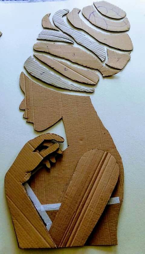 cut out pieces of cardboard sitting on top of a table