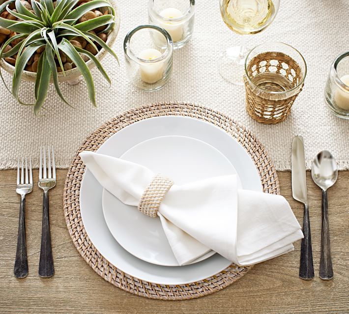 a place setting with silverware and candles