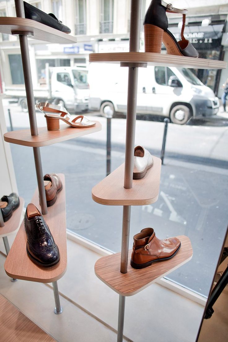 several pairs of shoes are on display in a window