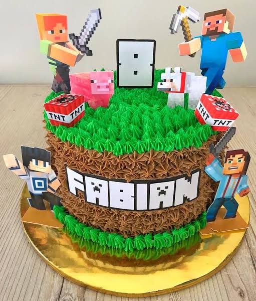 a cake made to look like an image of minecraft characters on top of grass