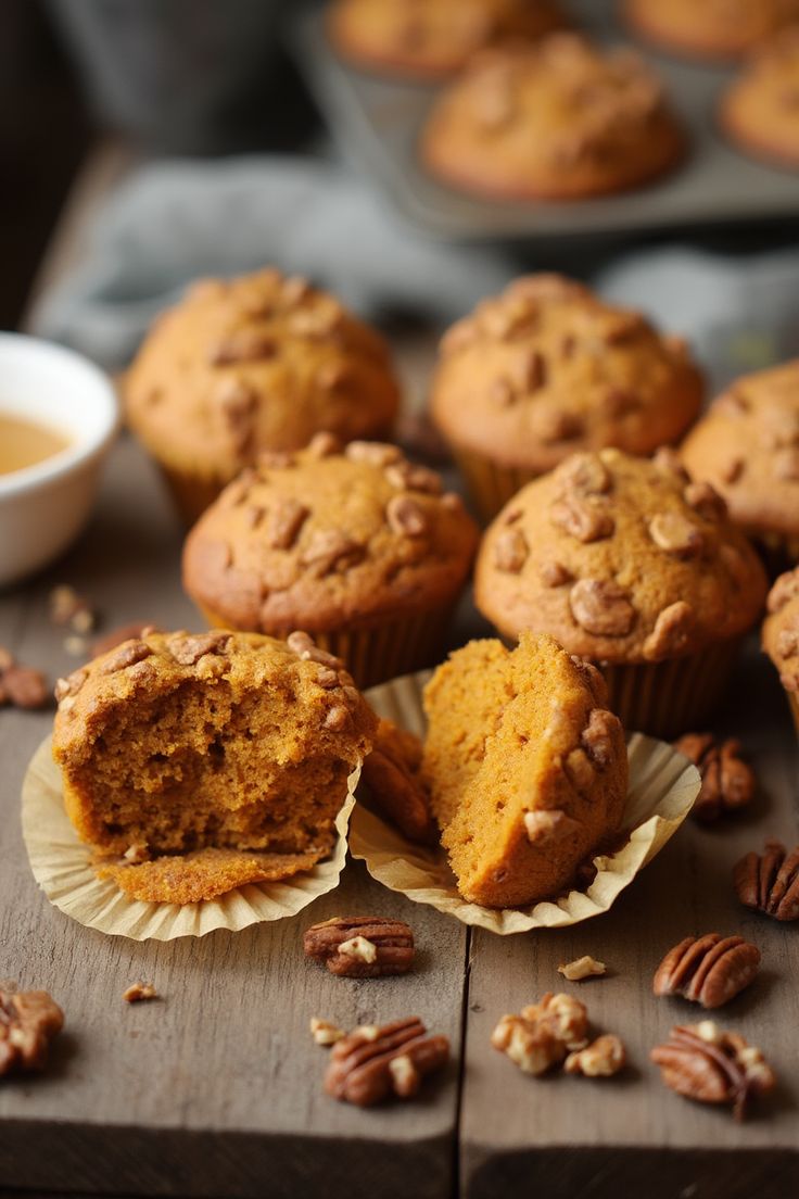 several muffins with pecans scattered around them