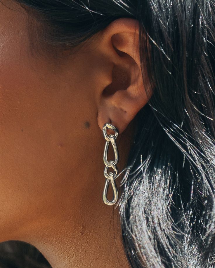 Switch up your style with these Jacqueline Drop Studs! The polished chain link drop adds a unique twist to your jewelry collection. With a perfect combination of fun and elegance, these studs are sure to make a statement. Be sure to take 'em for a spin! Material: 14K gold or rhodium plated brass Features: 1.65" drop, 0.3" width, Lead & Nickel free, post back Trendy Sterling Silver Chain Link Jewelry, Modern Twist Metal Earrings For Party, Trendy Silver Chain Link Earrings, Modern Link Jewelry For Party, Metal Jewelry With Modern Twist Chain, Modern Silver Chain Earrings, Chic Silver Chain Link Jewelry, Modern Twist Metal Chain Jewelry, Modern Twist Silver Jewelry For Party