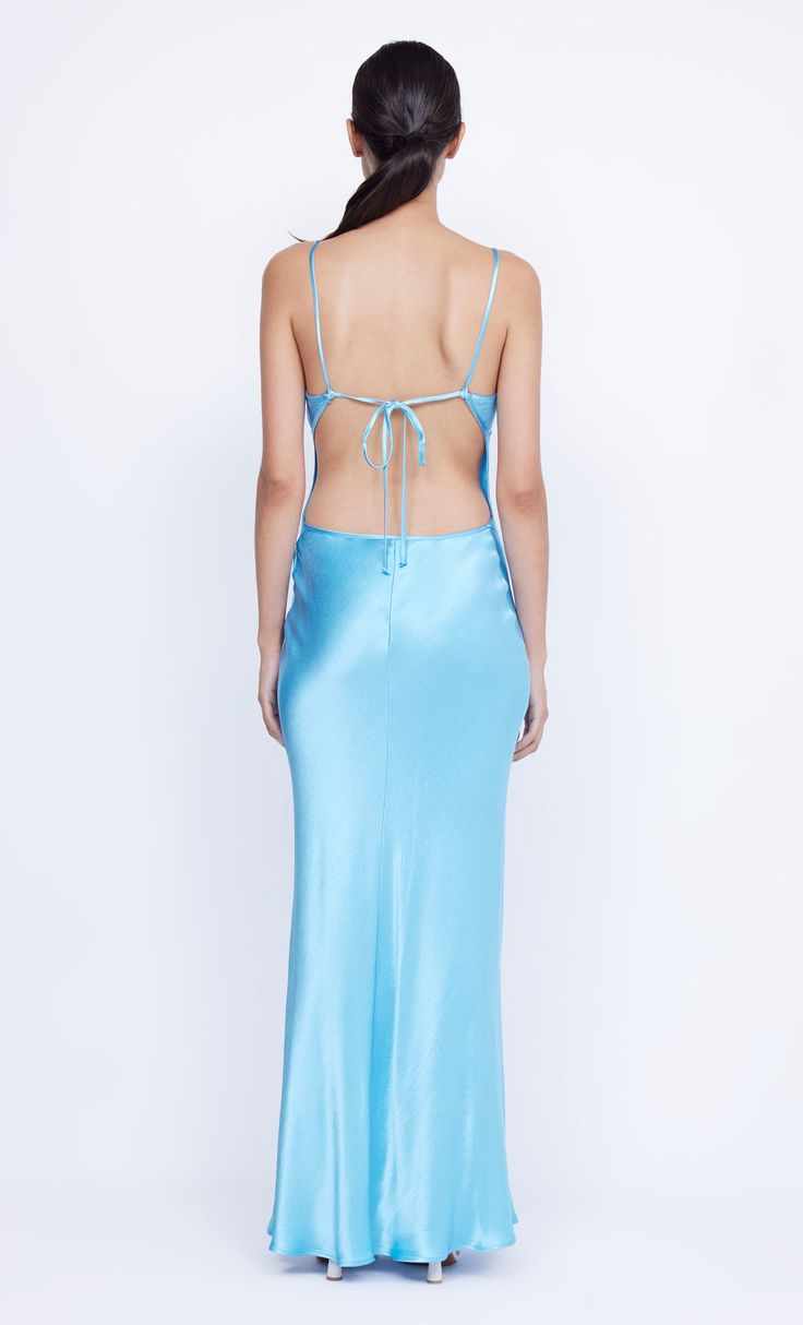 The elevated BEC + BRIDGE Margaux Keyhole Maxi Dress is crafted from a lustrous, topaz blue fabric in a flattering silhouette. The bias cut maxi dress features a v neckline, statement double keyhole cut-out detail and binding that travels and ties at the low cut, open back. V-neck Satin Maxi Dress With Side Slits, Maxi Length Satin Dress With Back Opening For Prom, Maxi Satin Dress With Back Opening For Prom, Blue V-neck Maxi Dress With Side Slits, Prom Maxi Dress With Bias Cut, Bias Cut Maxi Length Prom Dress, Blue Tie Back Slip Dress For Night Out, Floor-length Slip Dress With Back Opening, Gala Slip Dress With Tie Back In Maxi Length