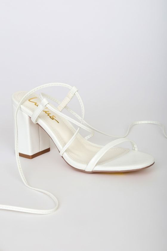 The Lulus Aribaa White Lace-Up High Heel Sandals will be your new fave shoes that give any look the perfect finishing touch! Smooth faux leather shapes these chic heels featuring a slender toe band and matching laces (with gold aglets) that crisscross at the vamp before wrapping and securing at the ankle. 3. 5" block heel. Cushioned insole. Rubber sole has nonskid markings. All Made Made Materials. Imported. Lulus | Aribaa White Lace-Up High Heel Sandal Heels. Elegant Synthetic Heels With Stacked Heel, Sleek High Block Heels With Wrapped Heel, Sleek Block Heels With Wrapped Open Heel, Elegant White Synthetic Block Heels, Sleek White Heels With Reinforced Heel, Elegant Synthetic Open Heel Block Heels, White Sleek Open Heel Heels, Sleek White Heels With Wrapped Heel, Sleek White Open Heel Heels