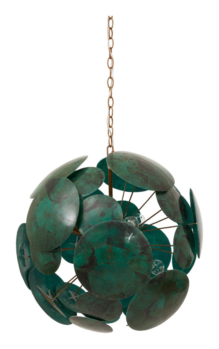 a green sculpture hanging from a chain