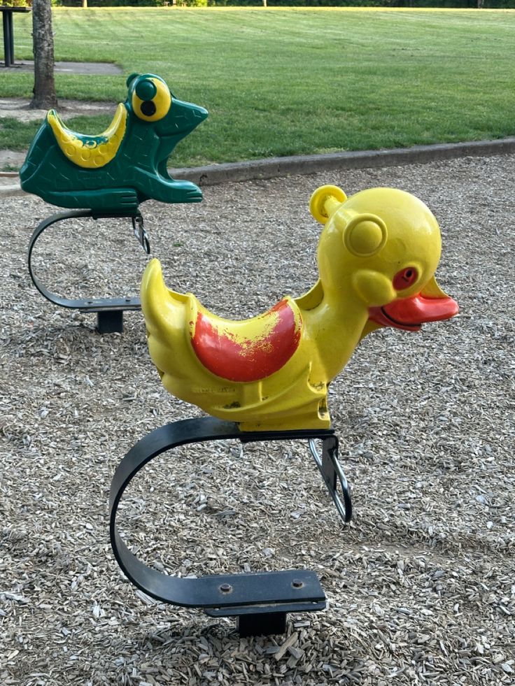 two children's toys are sitting in the gravel