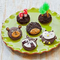 a green plate topped with little animal cakes