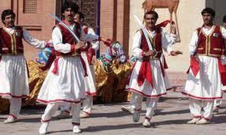 men dressed in red and white costumes are dancing