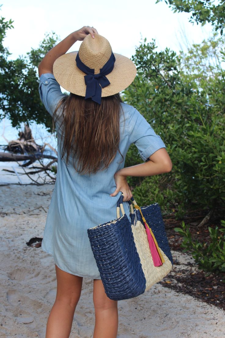 This over-sized straw tote is your go-to carryall for Saturday morning farmer's markets, family beach days or completing the perfect linen suit. Topped with ornamental wrapped handles and suede tassels, it is completed by a classic linen interior lining. This navy and natural structured tote feels modern and bohemian at once. Content:- Paper Straw- Linen Lining- Suede- Imported Size:- Width: 22" - Height: 12"- Depth: 6"- Handle Drop: 3.5" Chic Straw Beach Bag With Tassels, Chic Beach Straw Bag With Tassels, Chic Tassel Straw Beach Bag, Chic Blue Handwoven Straw Bag, Casual Straw Bag With Tassels For Vacation, Jute Straw Bag For Summer Outings, Blue Handwoven Straw Bag For Beach Season, Bohemian Beach Bag With Leather Handles For Summer, Chic Straw Bag With Tassels For Travel