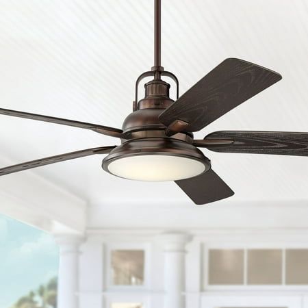 a ceiling fan that is hanging from the ceiling in a room with white walls and windows