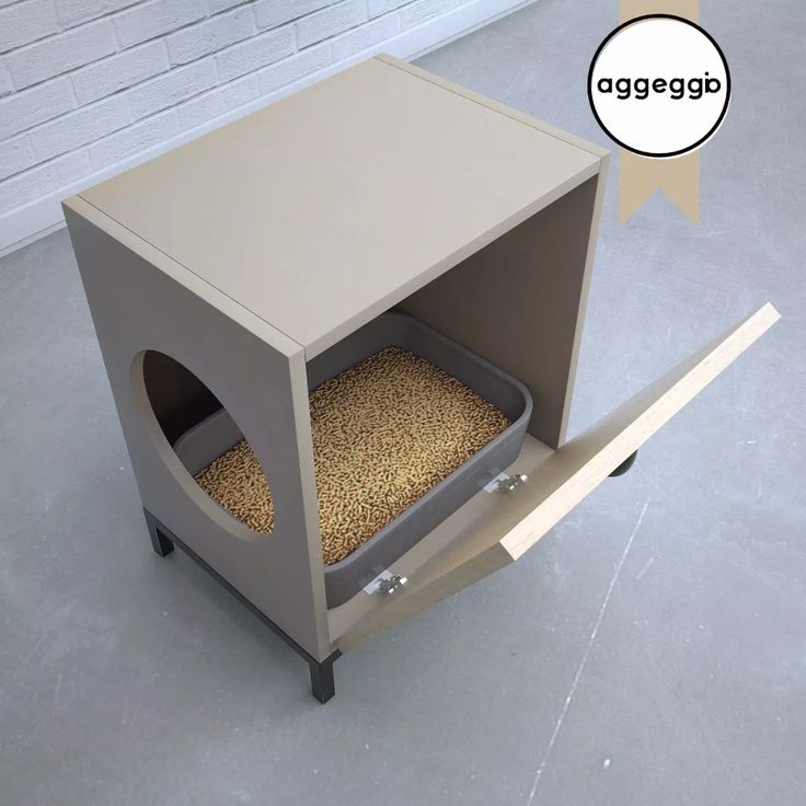 a dog house made out of cardboard with a cat in it's litter box