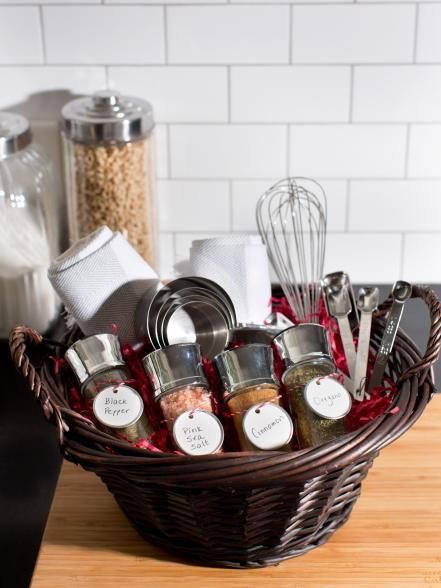 a wicker basket filled with spices and kitchen utensils