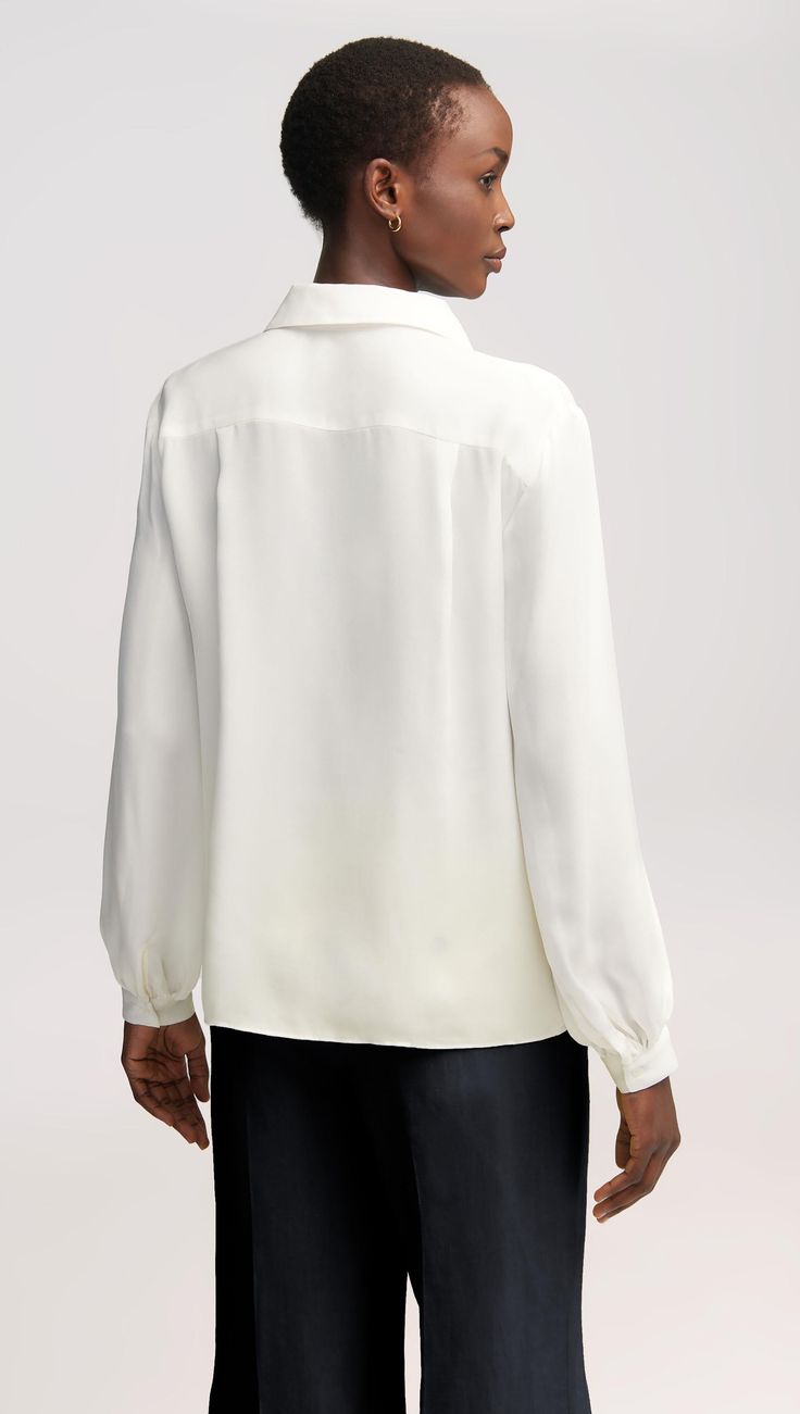 Here’s what happens when an everyday item piece gets an elegant twist. Made of airy Georgette silk, this versatile blouse features bubble sleeves, smart cuffs, and a relaxed fit for effortless layering. Pair with wide-leg trousers, heels, and bold accessories for a classy look that never misses. Elegant Puff Sleeve Tops For Layering, Classic Blouse With Balloon Sleeves And Button Cuffs, Cream Blouson Sleeves Top For Daywear, Workwear Blouse With Bishop And Cuffed Sleeves, Classic Formal Blouse With Balloon Sleeves, White Balloon Sleeve Blouse For Formal Occasions, Workwear Blouse With Cuffed Bishop Sleeves, Classic Formal Tops With Gathered Sleeves, Classic Tops For Workwear With Balloon Sleeves