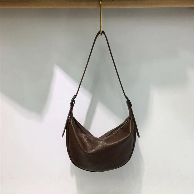 Elevate your style with our Simple Design Dumpling Shoulder Bag. Crafted from textured leather, this large-capacity handbag exudes sophistication in its solid, versatile design. Embrace the charm of street vintage fashion with this crossbody bag – a perfect blend of simplicity and timeless elegance. Lining Material: Polyester Main Material: PU Interior Zipper Pocket Interior Compartment Retro Everyday Hobo Tote Bag, Retro Everyday Tote Hobo Bag, Brown Retro Hobo Bag With Large Capacity, Retro Hobo Tote Bag For Everyday, Retro Brown Hobo Bag With Large Capacity, Retro Brown Hobo Bag Large Capacity, Vintage Everyday Baguette Tote Bag, Vintage Everyday Tote Baguette Bag, Vintage Tote Baguette Bag For Everyday