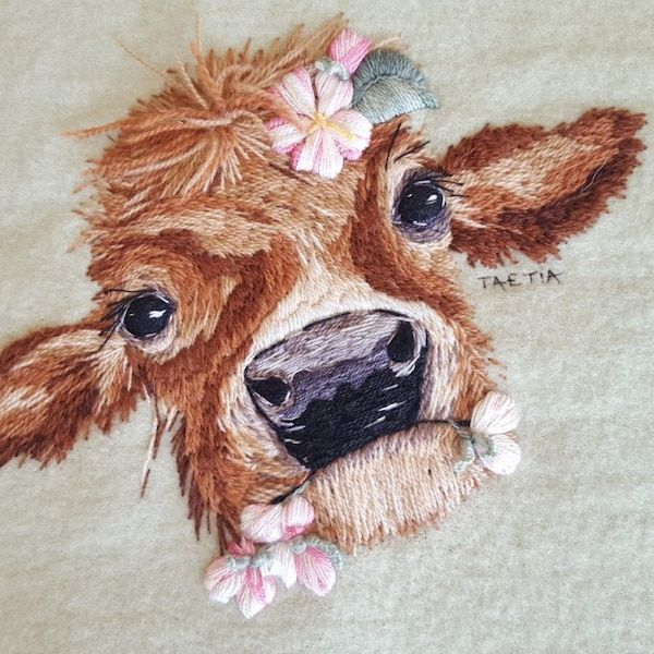 a close up of a cow with flowers on it's head