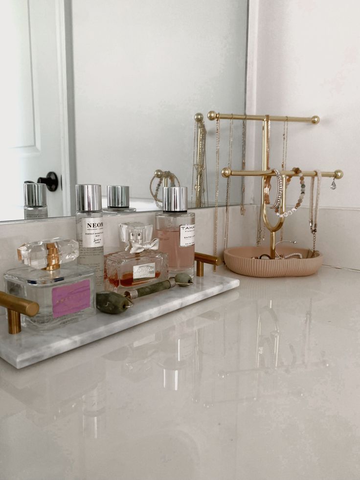 a bathroom counter with various items on it and a mirror in the backround